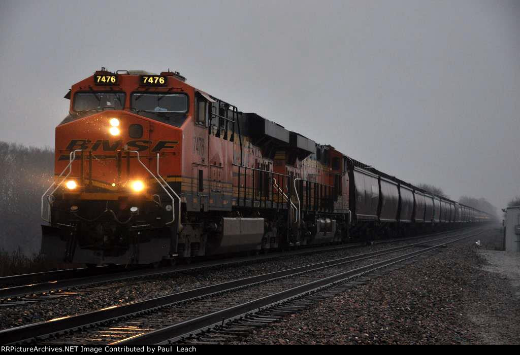 Grain train rolls west through the rain